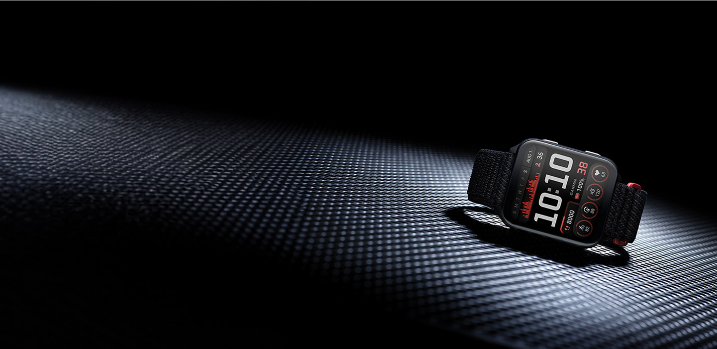 Smartwatch on a textured dark surface with a spotlight effect