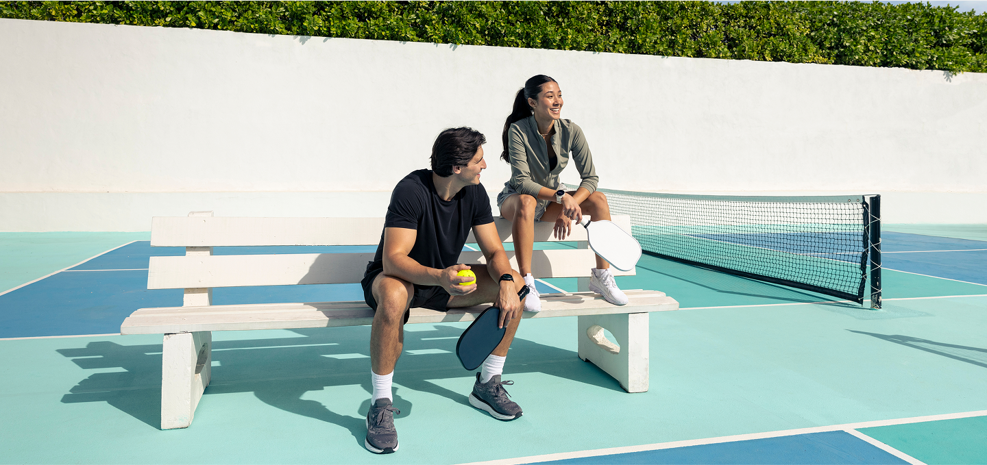 Man and a Woman Sitting on a tennis court 1